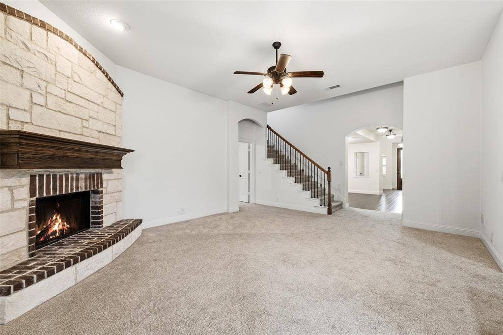 Featuring stone fireplace with wood mantle