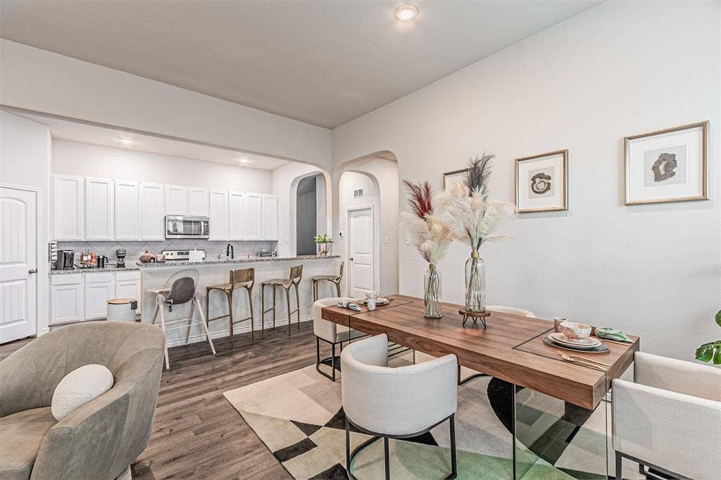 Open-concept living space featuring wood-finish flooring, recessed lighting, and a neutral color palette