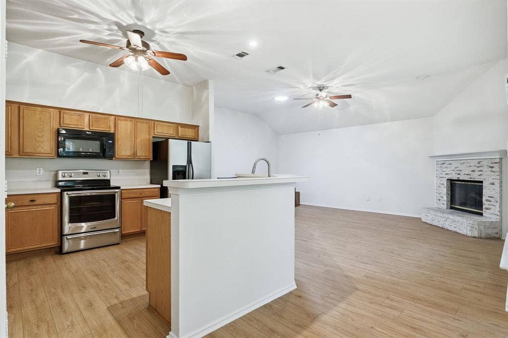 Open-concept living space with wood-finish flooring