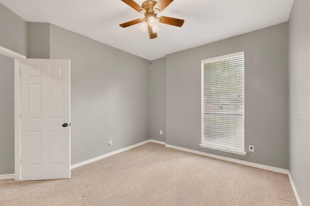 712 Water Oak Drive, Plano, TX 75025 Neutral-toned room featuring carpet flooring, a window with blinds, and a ceiling fan with light fixture