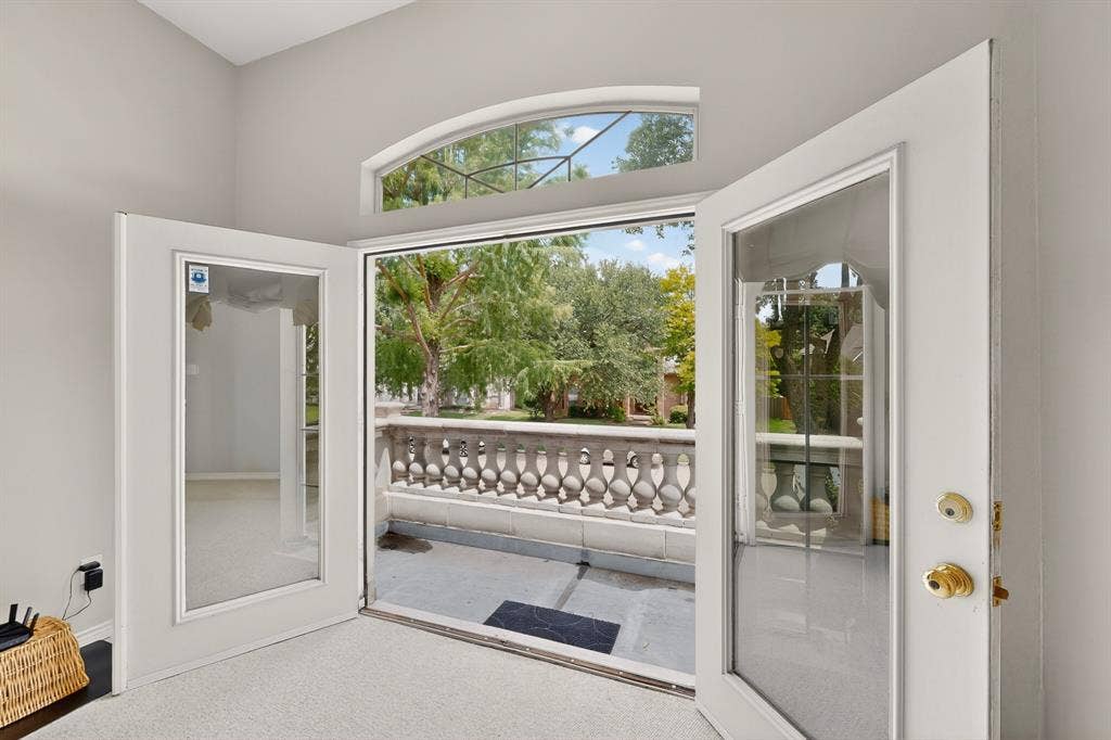 712 Water Oak Drive, Plano, TX 75025 French doors opening to an exterior balcony featuring a decorative balustrade