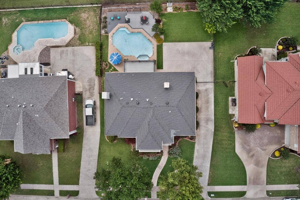 712 Water Oak Drive, Plano, TX 75025 Residential property featuring a grey shingle roof, concrete driveway, and established green lawn