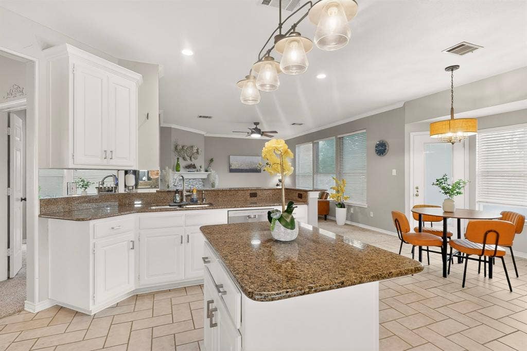 712 Water Oak Drive, Plano, TX 75025 Kitchen featuring white cabinetry, granite countertops, a central island, tile flooring, and recessed lighting