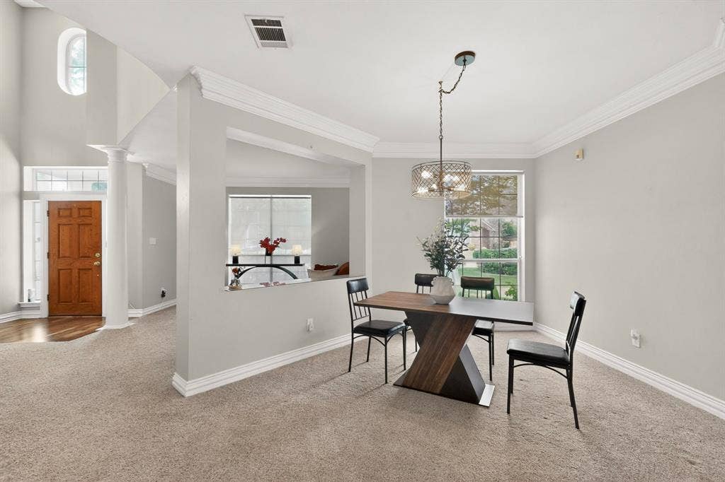 712 Water Oak Drive, Plano, TX 75025 Dining area with broad window and contemporary chandelier