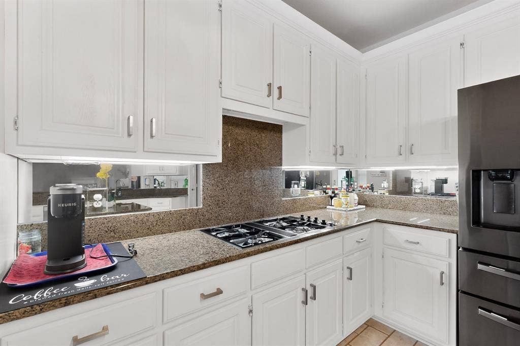 712 Water Oak Drive, Plano, TX 75025 Kitchen featuring white cabinetry, granite countertops, and a built-in gas cooktop