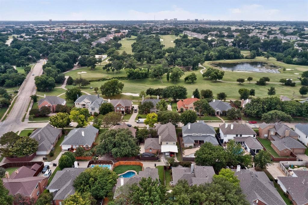 712 Water Oak Drive, Plano, TX 75025 Established residential neighborhood featuring mature trees and a golf course with a pond