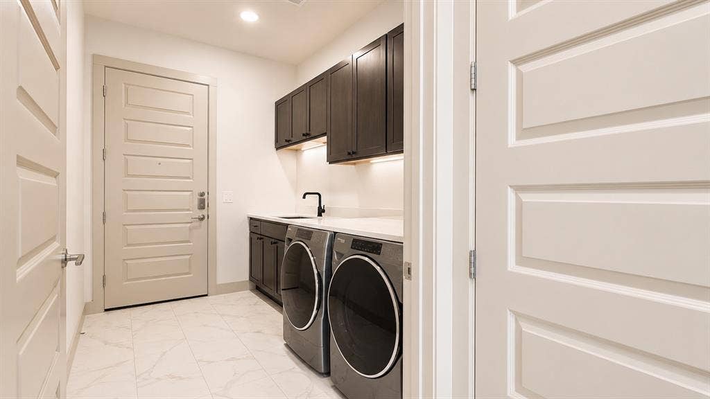 3330 Oak Grove Avenue, #1307, Dallas, TX 75204 Utility room featuring dark wood-finish cabinetry, a sink with a matte black faucet, and light stone-look countertops