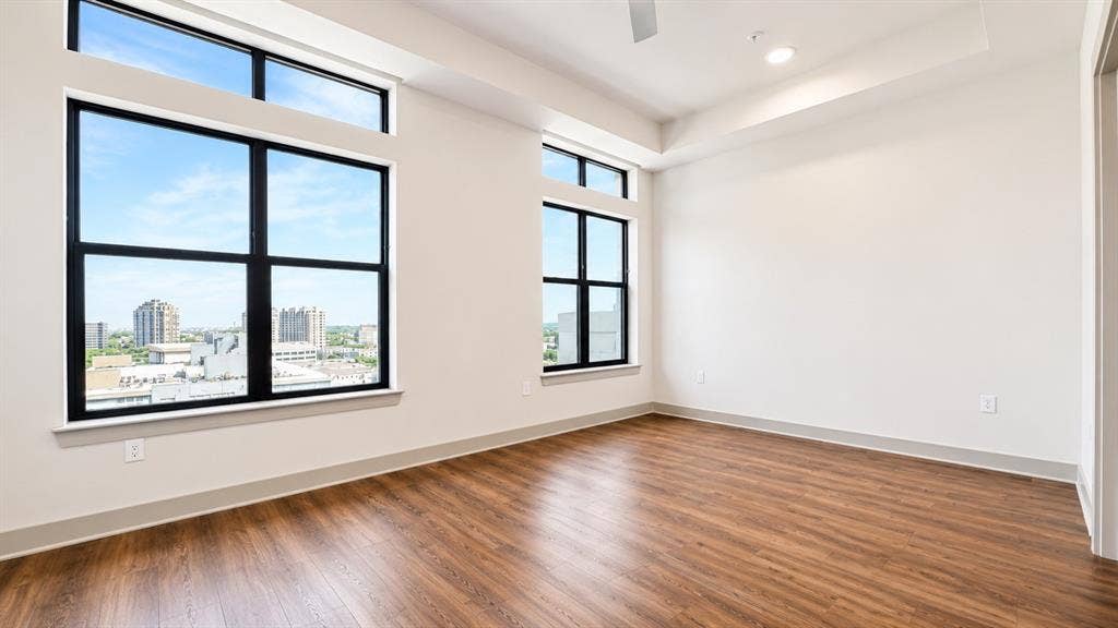 3330 Oak Grove Avenue, #1307, Dallas, TX 75204 Expansive windows with black framing, wood-finish flooring, recessed lighting, ceiling fan, and high ceilings
