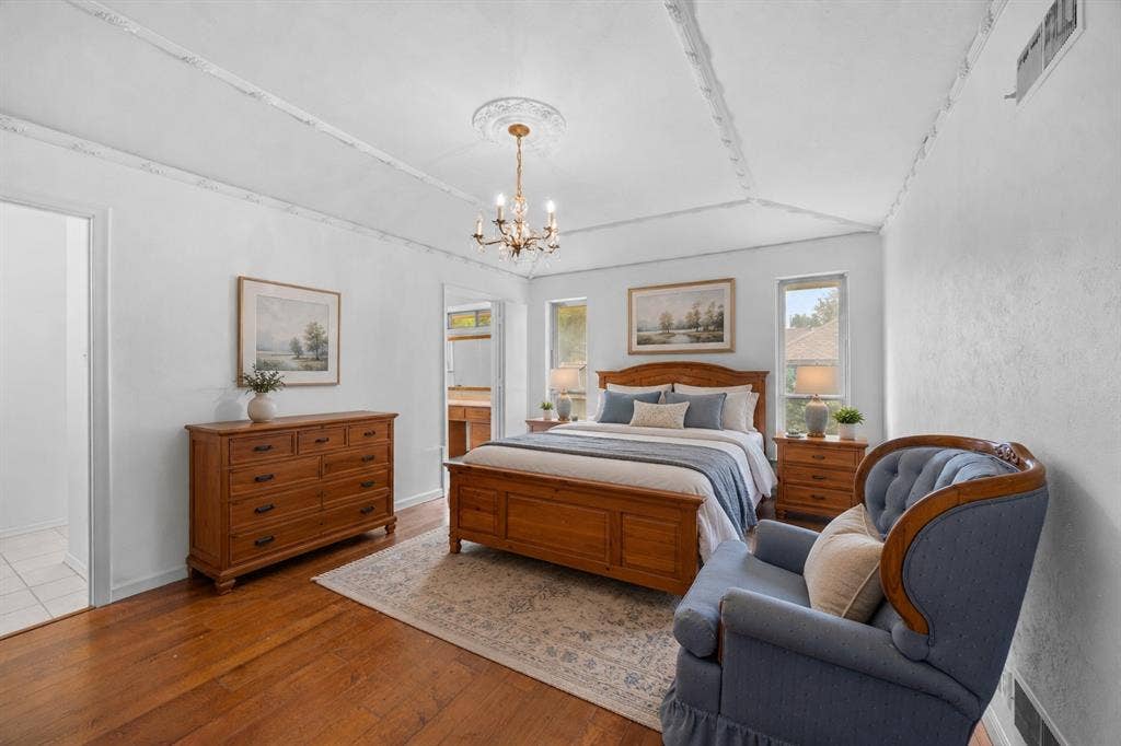 2125 Woodbrook Street, Denton, TX 76205 Hardwood flooring throughout, featuring a vaulted ceiling with decorative trim