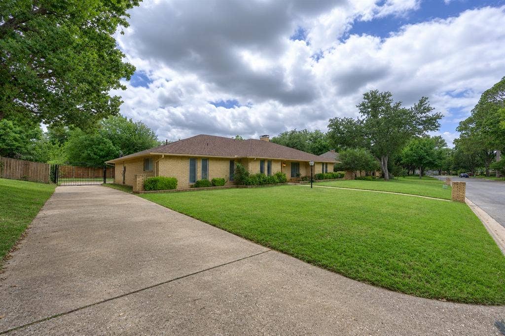 2125 Woodbrook Street, Denton, TX 76205 Single-story brick exterior with a low-pitch roof