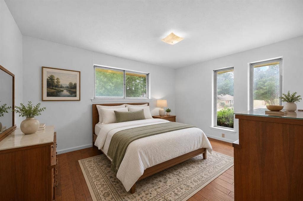 2125 Woodbrook Street, Denton, TX 76205 Bedroom featuring wood-finish flooring, two large windows, a single built-in ceiling light fixture, and light-colored walls