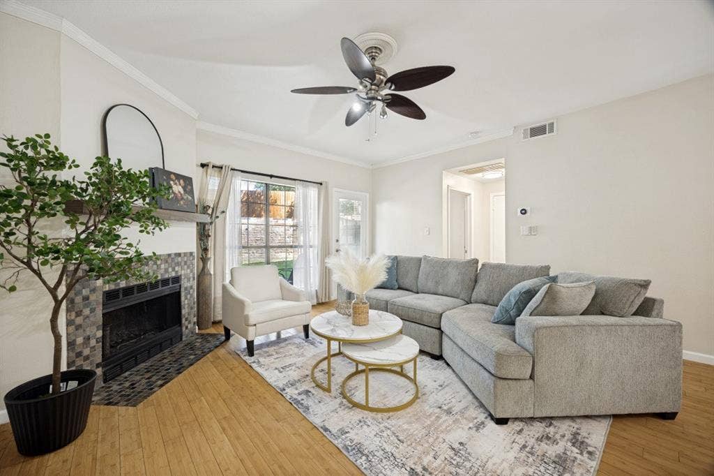 Living area featuring wood-finish flooring and a ceiling fan
