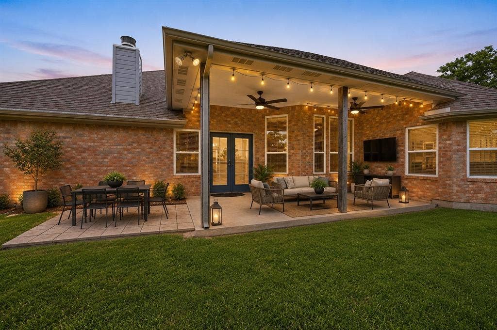 *Virtually Staged**Spacious covered patio with ceiling fans and string lighting