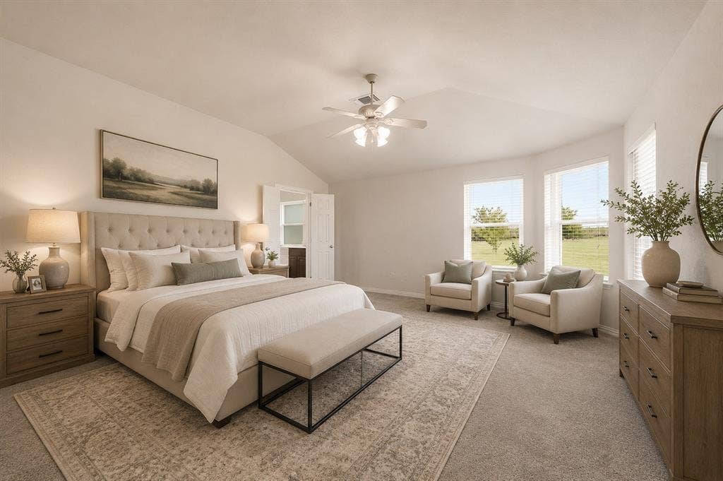 **Virtually Staged**Spacious sleeping area featuring vaulted ceilings, an upholstered bed frame, two large windows with blinds, a ceiling fan, and carpeted flooring