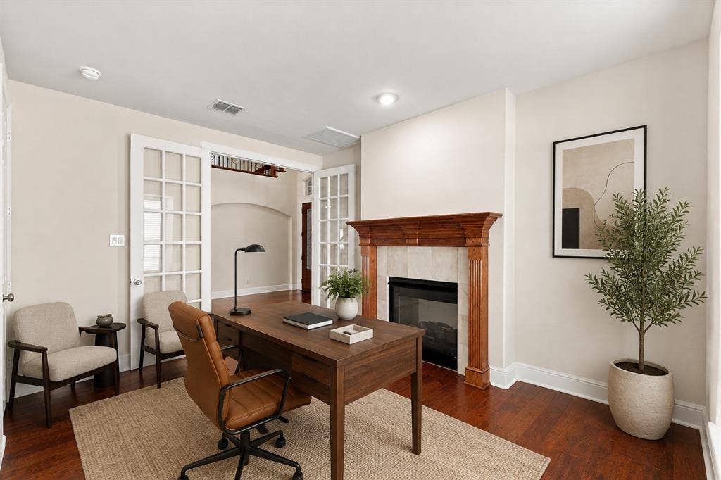 509 Wentworth Lane, Murphy, TX 75094 Virtually Staged Hardwood flooring throughout, featuring a fireplace with a wood mantel and tile surround