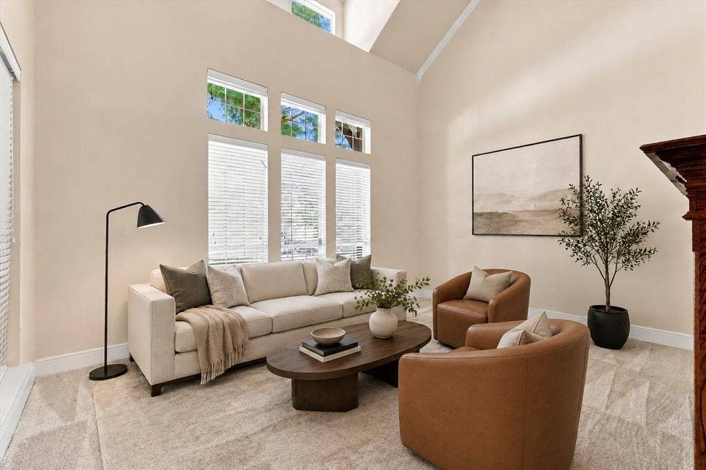509 Wentworth Lane, Murphy, TX 75094 Virtually Staged High vaulted ceilings, multiple transom windows, light-toned carpeting, and a wood mantelpiece