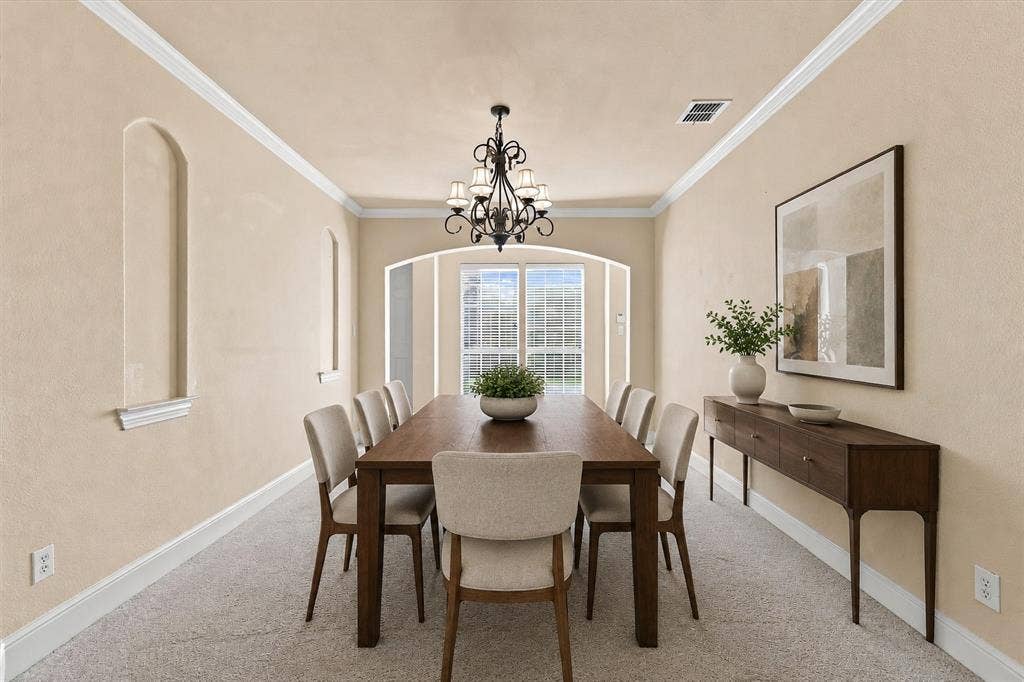 509 Wentworth Lane, Murphy, TX 75094 Virtually Staged Recessed wall niches, crown molding, arched entryways, and a wrought iron chandelier