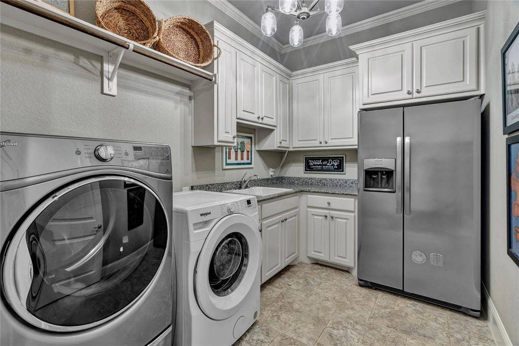 6412 Preferred Drive, Fort Worth, TX 76179 Utility room featuring shaker-style cabinetry, a built-in sink, stone countertops, and tile flooring
