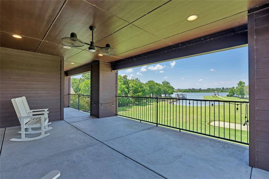 6412 Preferred Drive, Fort Worth, TX 76179 Expansive covered patio featuring a concrete surface, overhead ceiling fans, recessed lighting, and a black metal railing