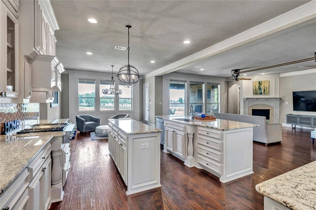 6412 Preferred Drive, Fort Worth, TX 76179 Open-concept living area featuring rich wood-finish flooring throughout
