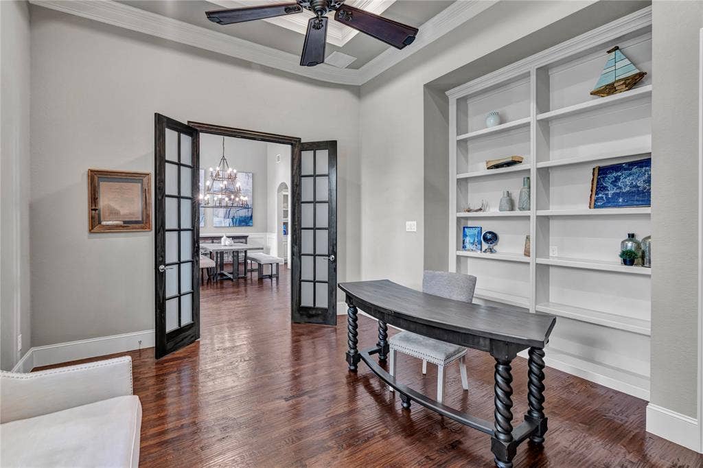 6412 Preferred Drive, Fort Worth, TX 76179 Dedicated office featuring dark wood-finish flooring, recessed built-in shelving, and a coffered ceiling with a ceiling fan