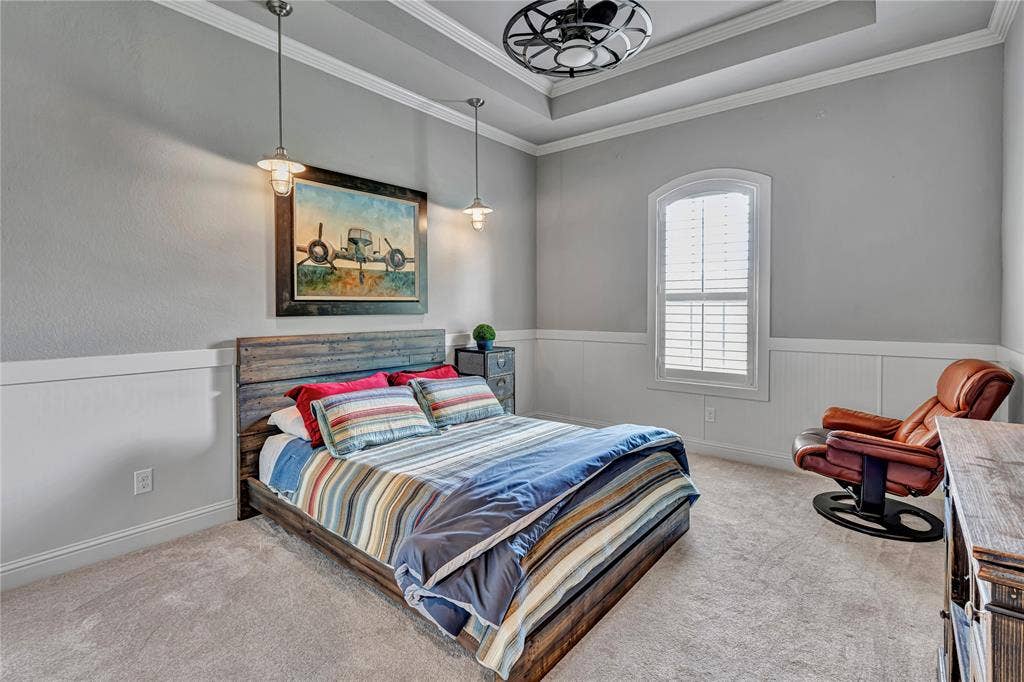 6412 Preferred Drive, Fort Worth, TX 76179 Carpeted room featuring a tray ceiling with a ceiling fan, crown molding, and wainscoting
