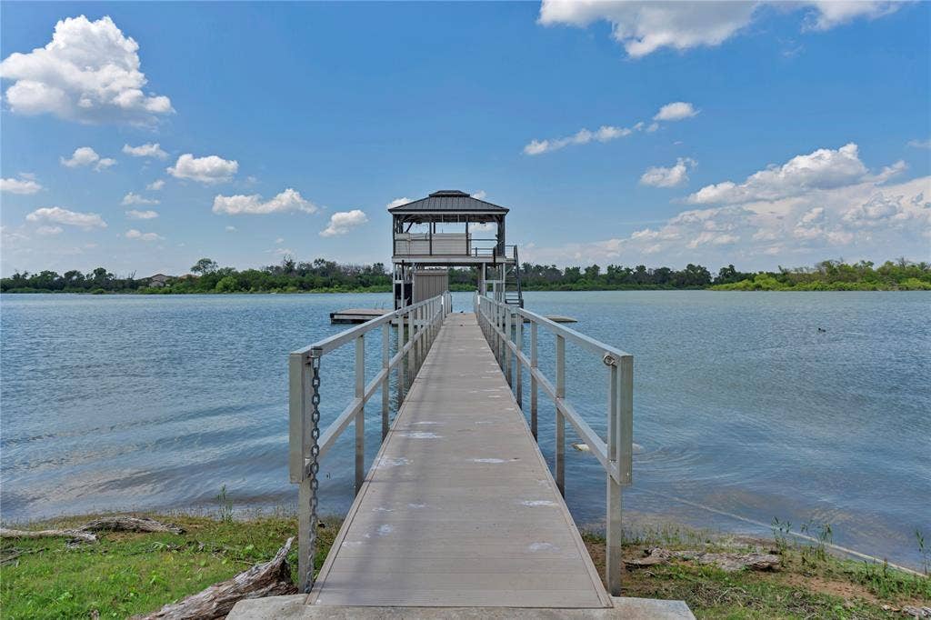 6412 Preferred Drive, Fort Worth, TX 76179 Private dock with a covered two-story boathouse featuring an open-air upper deck