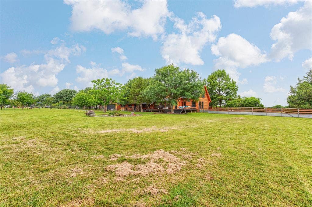 View of the back of the home and deck area from the SE corner of the property
