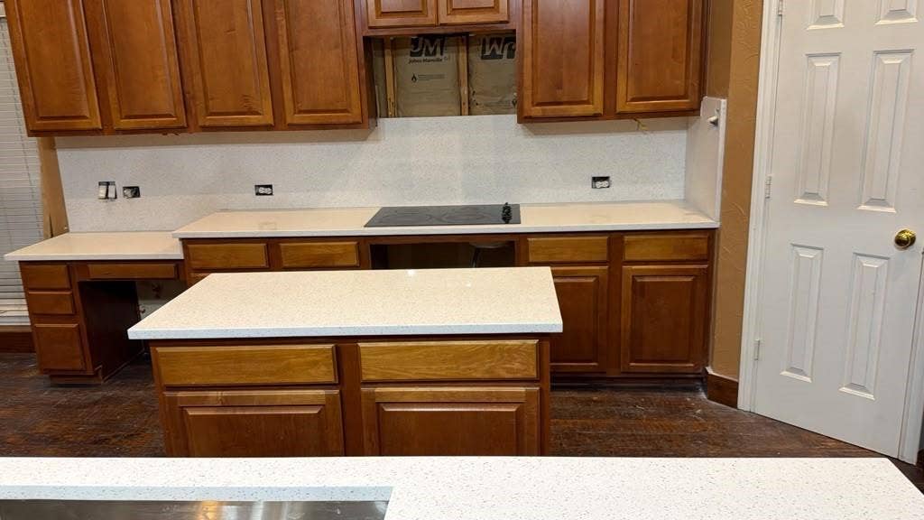 4506 Burnhill Drive, Plano, TX 75024 Kitchen featuring wood cabinetry, white countertops, and a central island