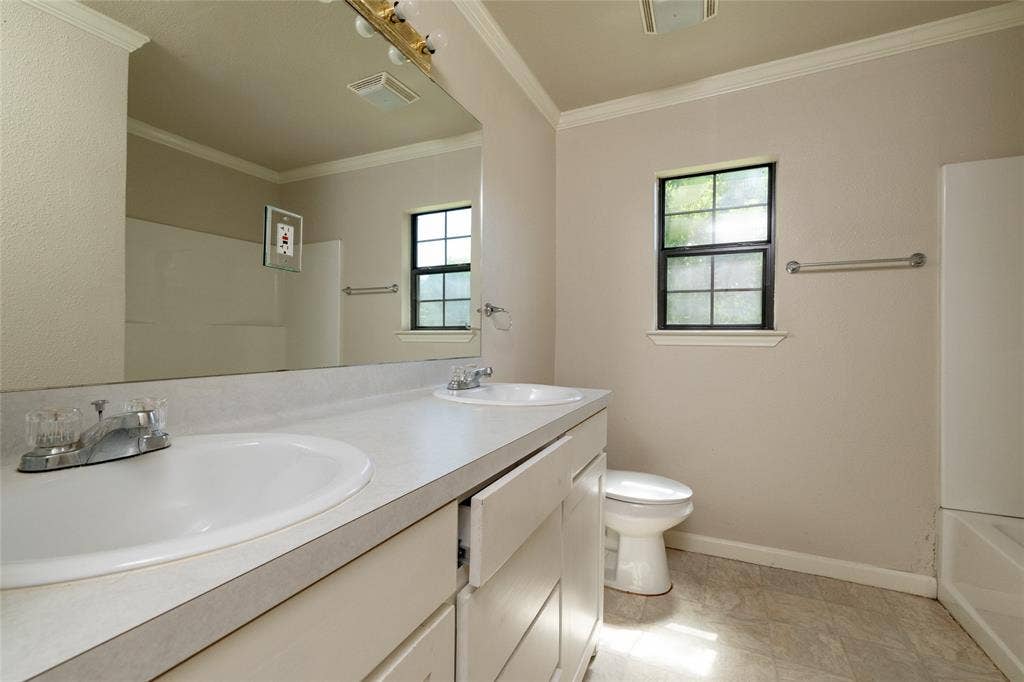313 N Roe Street, White Settlement, TX 76108 Dual-sink vanity with ample counter space and integrated storage