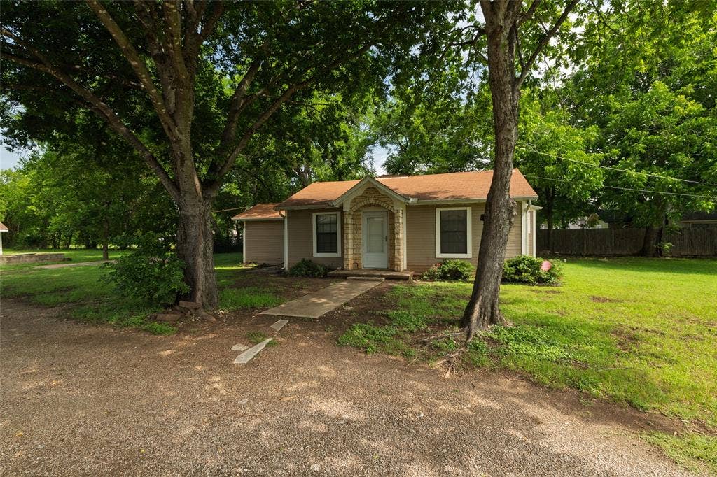 313 N Roe Street, White Settlement, TX 76108 Single-story residence featuring a neutral-toned exterior and a brown shingle roof