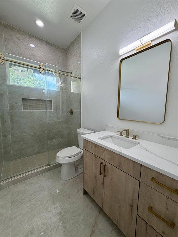 2823 Curvilinear Court, Dallas, TX 75227 Modern bathroom featuring a wood-finish vanity with a white countertop and integrated sink 1st floor