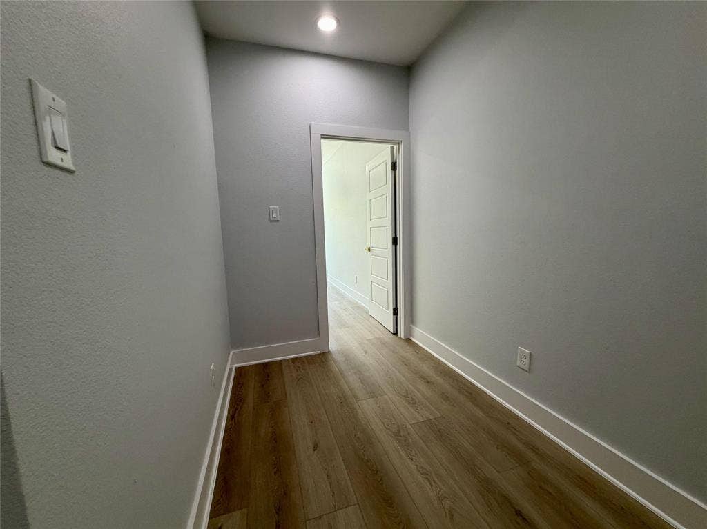2823 Curvilinear Court, Dallas, TX 75227 Hallway featuring wood-finish flooring, light gray walls, white baseboards, and recessed lighting