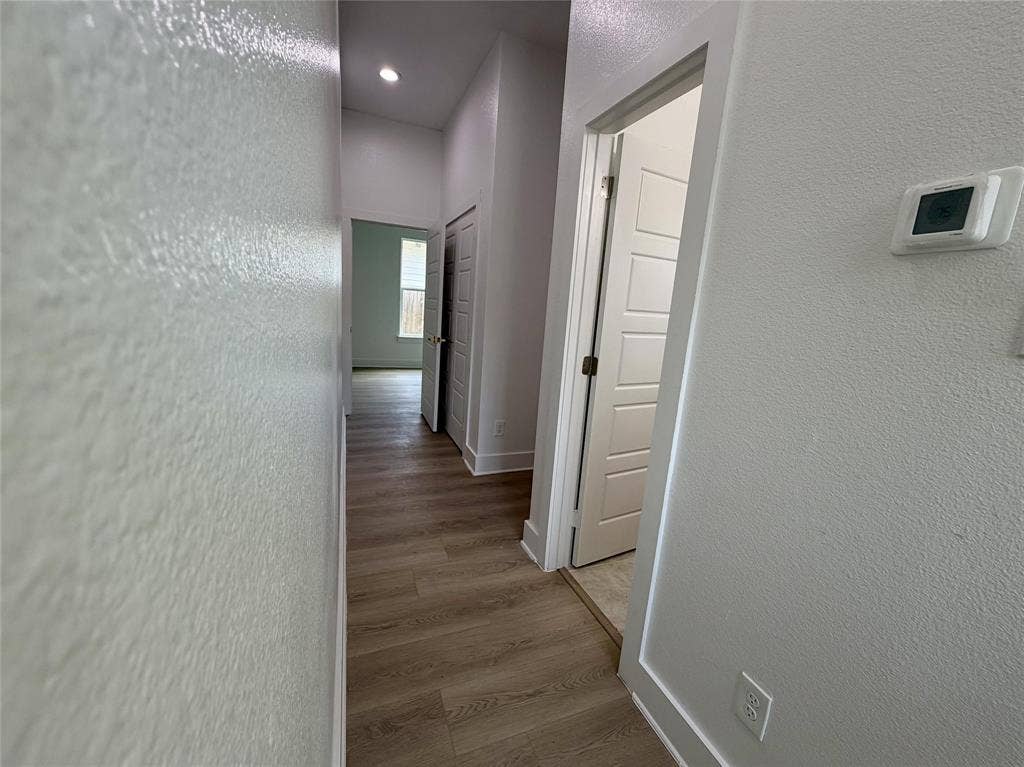 2823 Curvilinear Court, Dallas, TX 75227 Hallway featuring wood-finish flooring, recessed lighting, and a digital thermostat