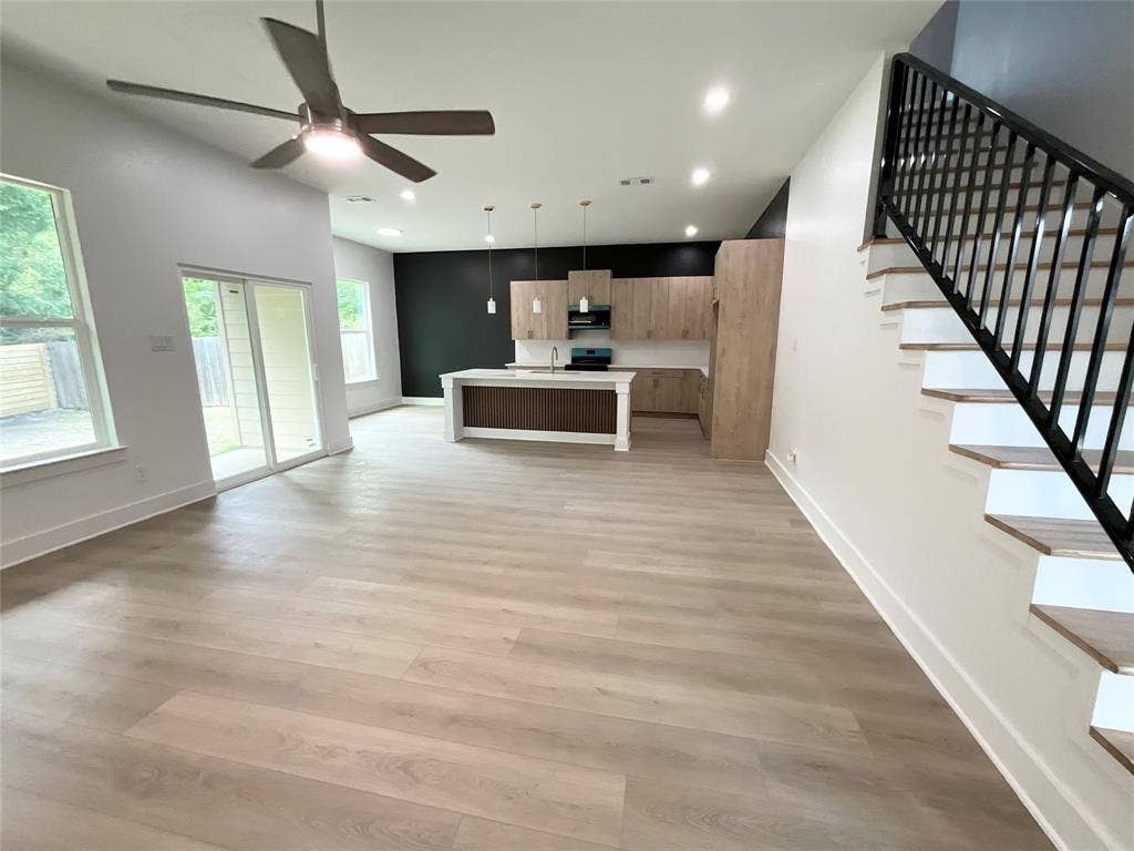 2823 Curvilinear Court, Dallas, TX 75227 Spacious open-concept interior featuring light wood-finish flooring throughout