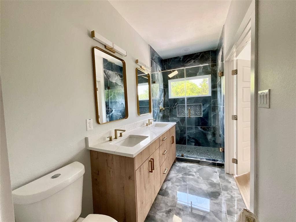 2823 Curvilinear Court, Dallas, TX 75227 Modern bathroom featuring a dual vanity with wood-finish cabinetry and quartz countertops