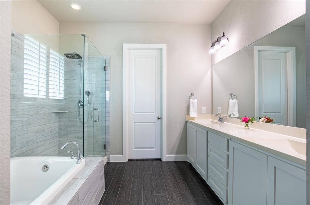 721 Matchbox Street, Argyle, TX 76226 Spacious primary bathroom with walk-in glass shower, premium fixtures, and oversized walk-in closet.