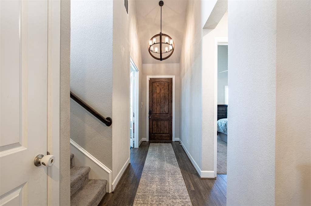721 Matchbox Street, Argyle, TX 76226 Large foyer with wood flooring and beautiful lighting.