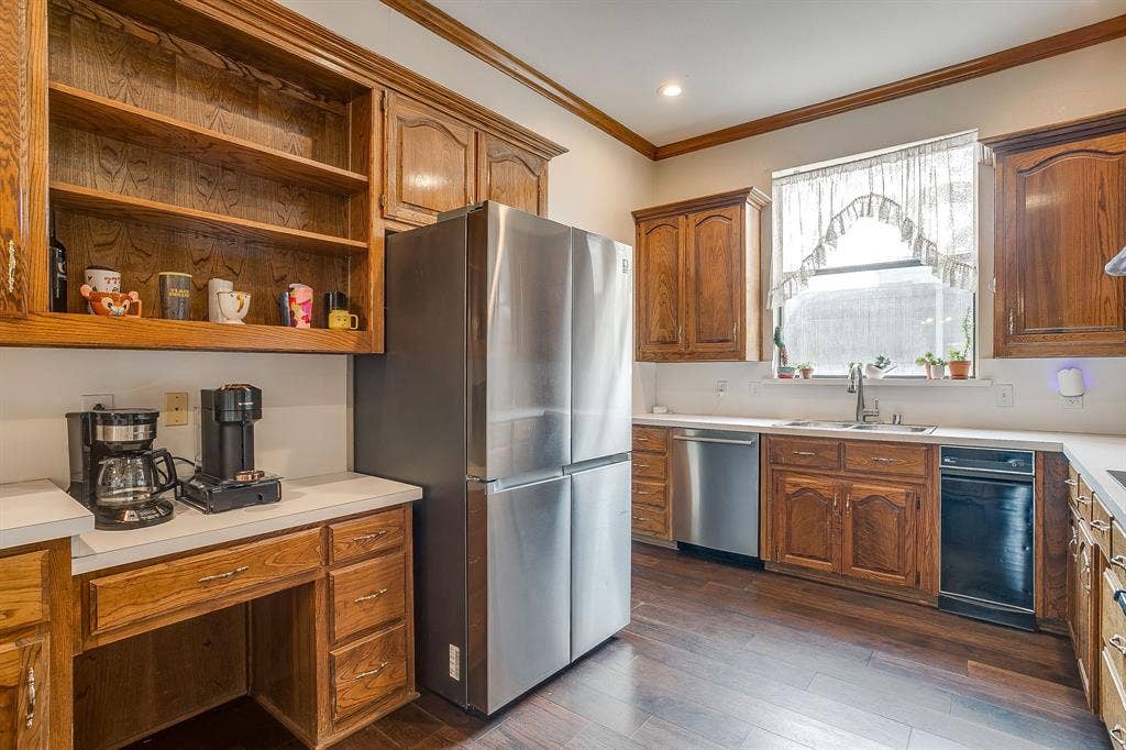 4624 Reunion Drive, Plano, TX 75024 Kitchen featuring wood cabinetry, light-toned countertops, a stainless steel appliances and wood flooring