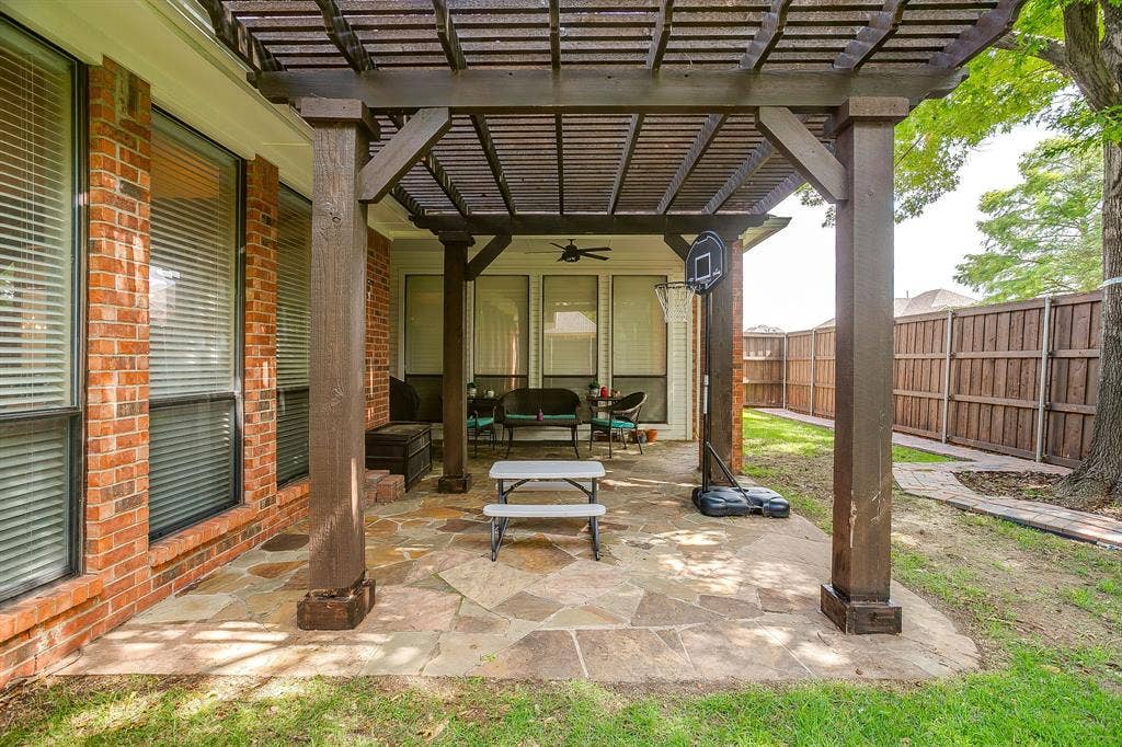 4624 Reunion Drive, Plano, TX 75024 Covered patio featuring a wood pergola and irregular flagstone paving
