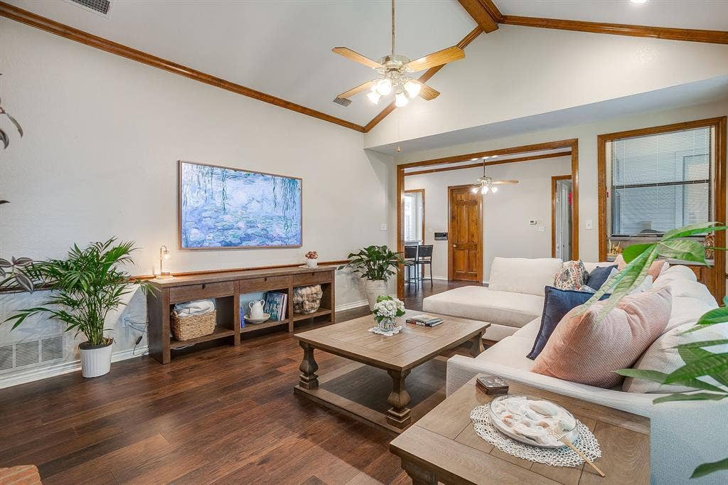 4624 Reunion Drive, Plano, TX 75024 Living area featuring a vaulted ceiling with exposed wood beams and a ceiling fan