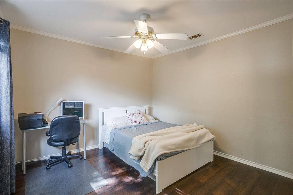 4624 Reunion Drive, Plano, TX 75024 Warm-toned interior with crown molding, ceiling fan with integrated lights and wood flooring