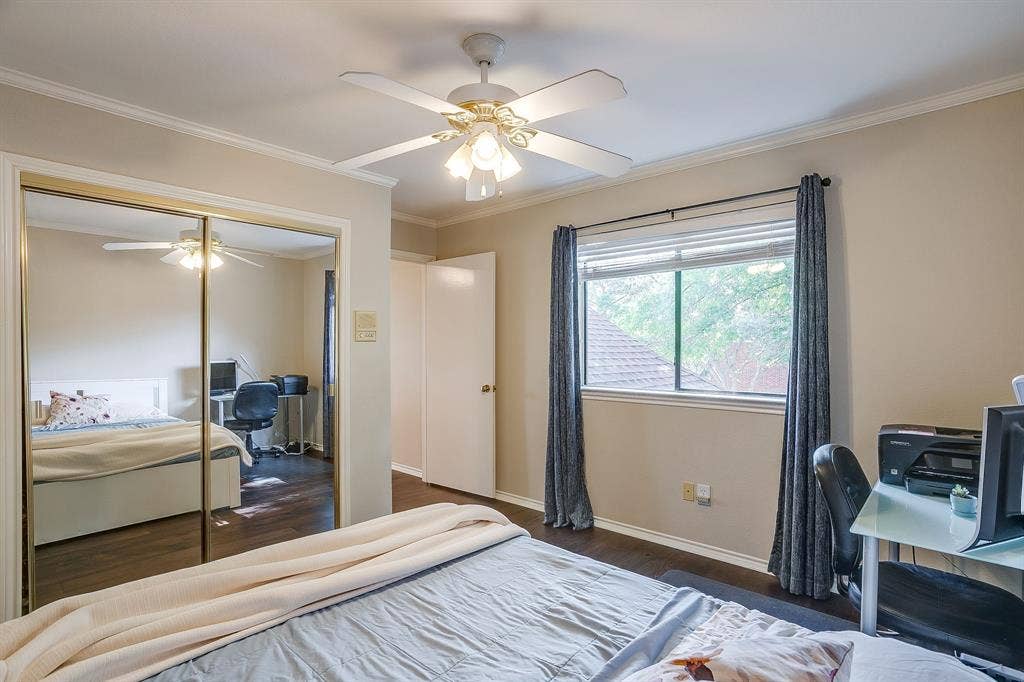 4624 Reunion Drive, Plano, TX 75024 Bedroom featuring dark wood flooring, a ceiling fan with integrated lighting, a window with blinds, and mirrored closet doors