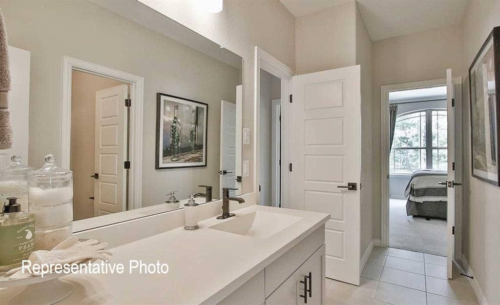 1324 Gardendale Hollow Lane, Anna, TX 75409 Bathroom vanity featuring a single basin, dark bronze faucet, and light-toned countertop