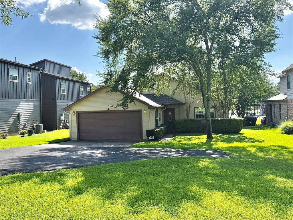 194 Bushwhacker Drive, Mabank, TX 75156 Attached two-car garage with a lush St. Augustine lawn stretching to the water's edge.