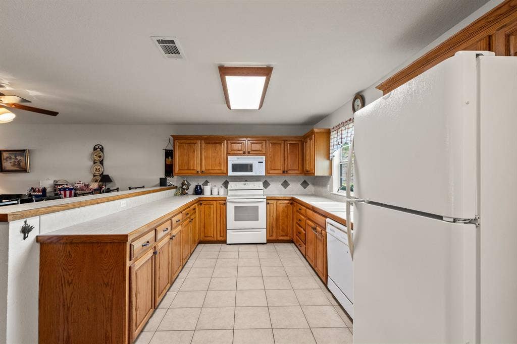 194 Bushwhacker Drive, Mabank, TX 75156 Functional kitchen layout designed for everyday living and entertaining.