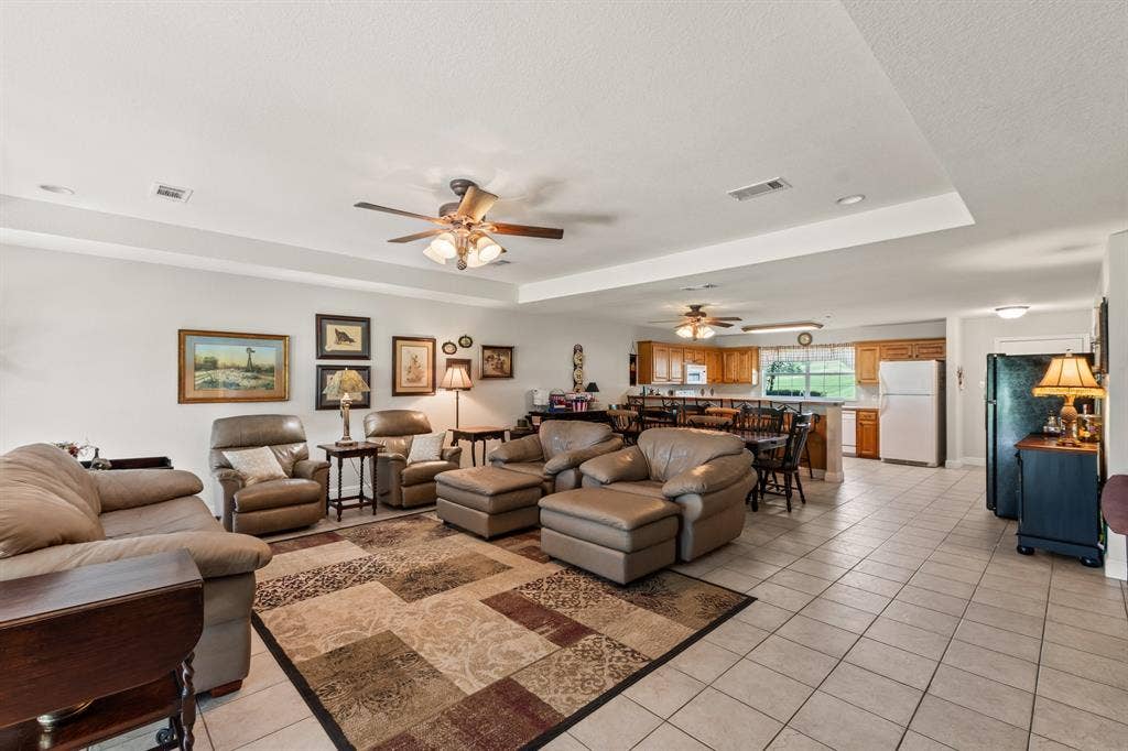 194 Bushwhacker Drive, Mabank, TX 75156 Open-concept living area with seamless views of the dining space and spacious kitchen.