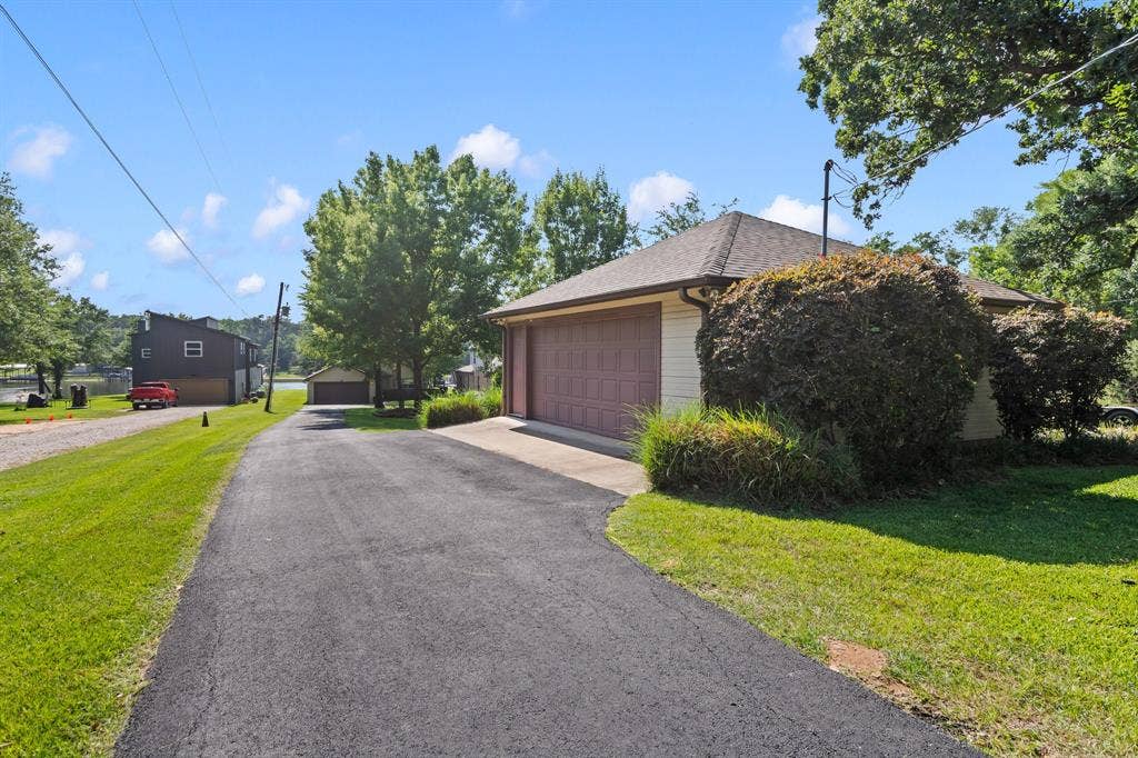 194 Bushwhacker Drive, Mabank, TX 75156 Spacious property featuring both attached and detached garages, offering plenty of room for vehicles and lake toys.