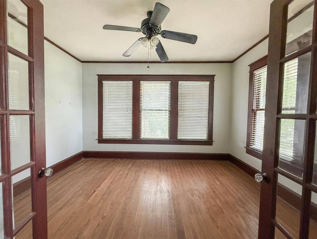 2749 Mcgregor South Loop, McGregor, TX 76657 Room featuring wood-finish flooring, dark wood trim, and a ceiling fan