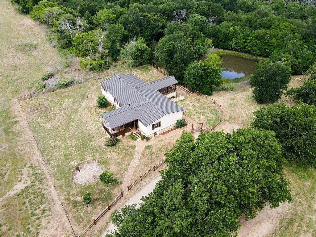 2749 Mcgregor South Loop, McGregor, TX 76657 Aerial perspective showcasing a single-story residence with a dark metal roof
